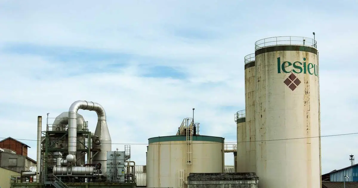 A person being interviewed for a US visa at an embassy, looking nervous as the consular officer asks questions